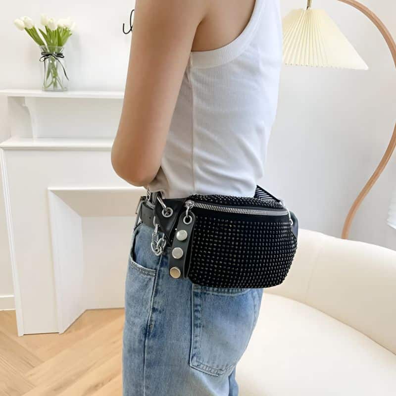 Women's shiny leather fanny pack worn around the waist