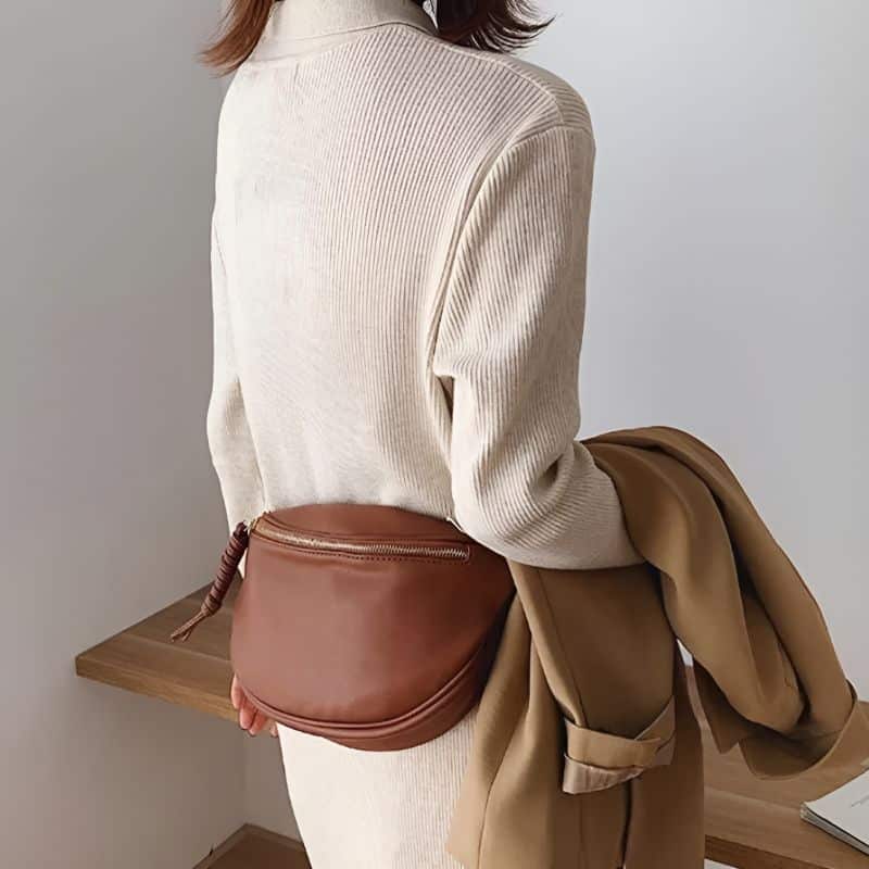 Woman wearing winter fanny pack around the waist