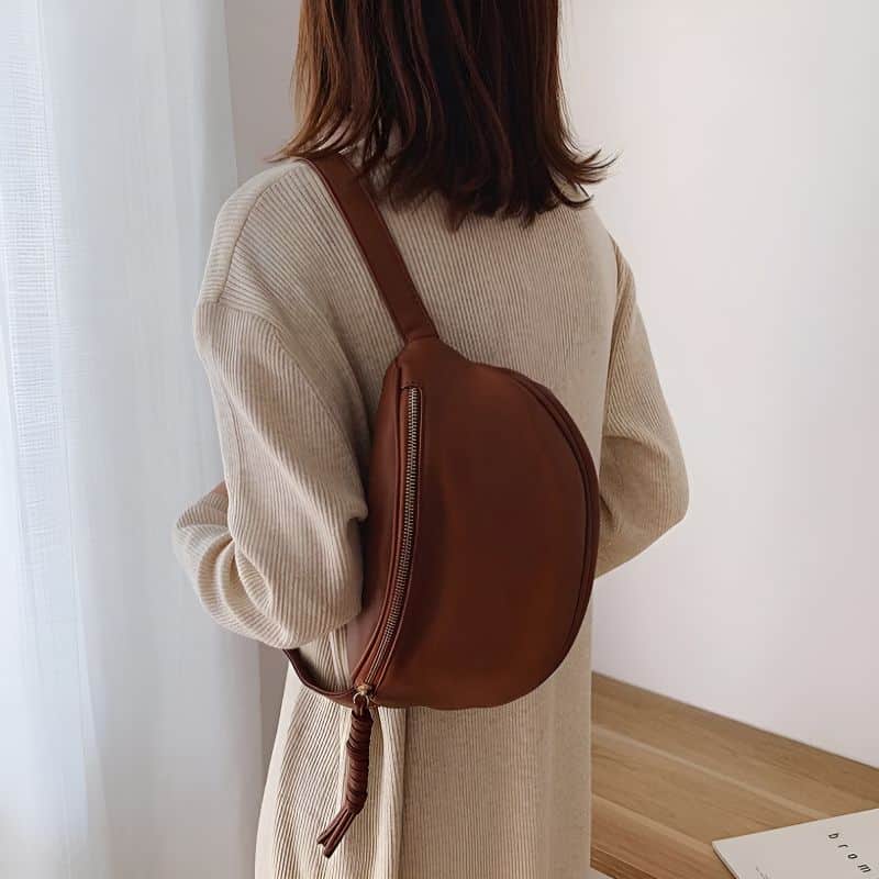 Woman wearing winter fanny pack on the shoulder