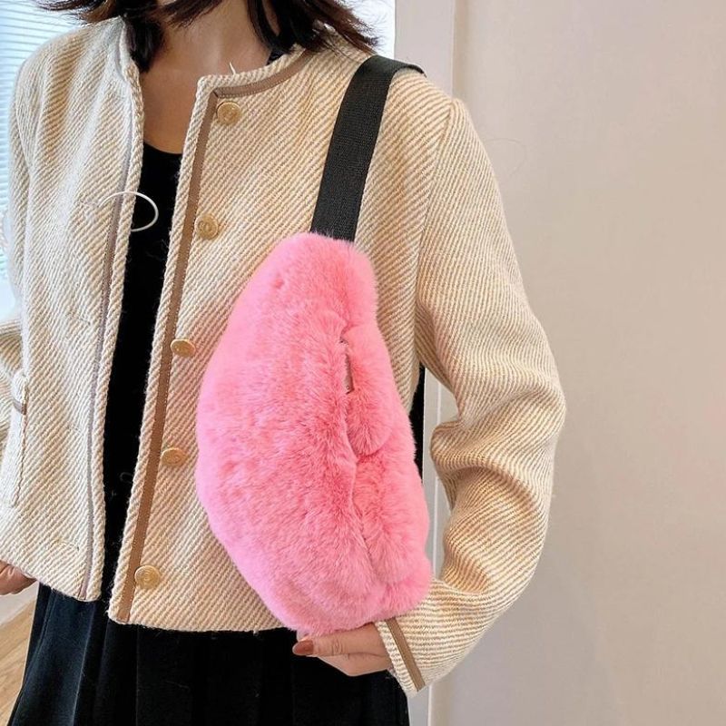 Pink fur fanny pack on the shoulder
