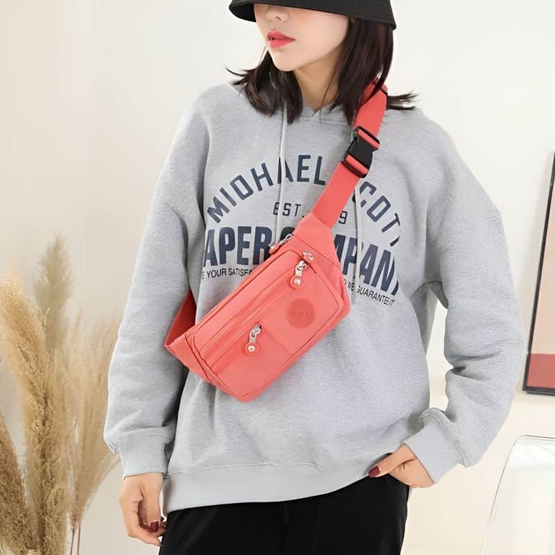 Pink multi-pocket fanny pack with shoulder strap